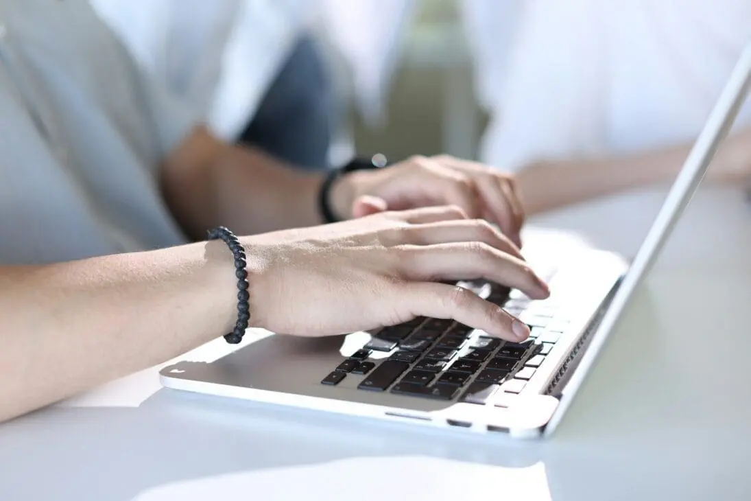 Hands typing blog post in quiet space for blogging with anxiety