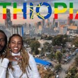 A smiling Ethiopian couple dressed in traditional clothing poses in the foreground, with the skyline of Addis Ababa in the background. Above them, the word "ETHIOPIA" is boldly displayed in the national flag colors, incorporating the country's emblem into the "O".