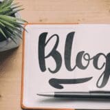 Handwritten word 'Blog' on white paper, symbolizing the start of a new blogging journey.