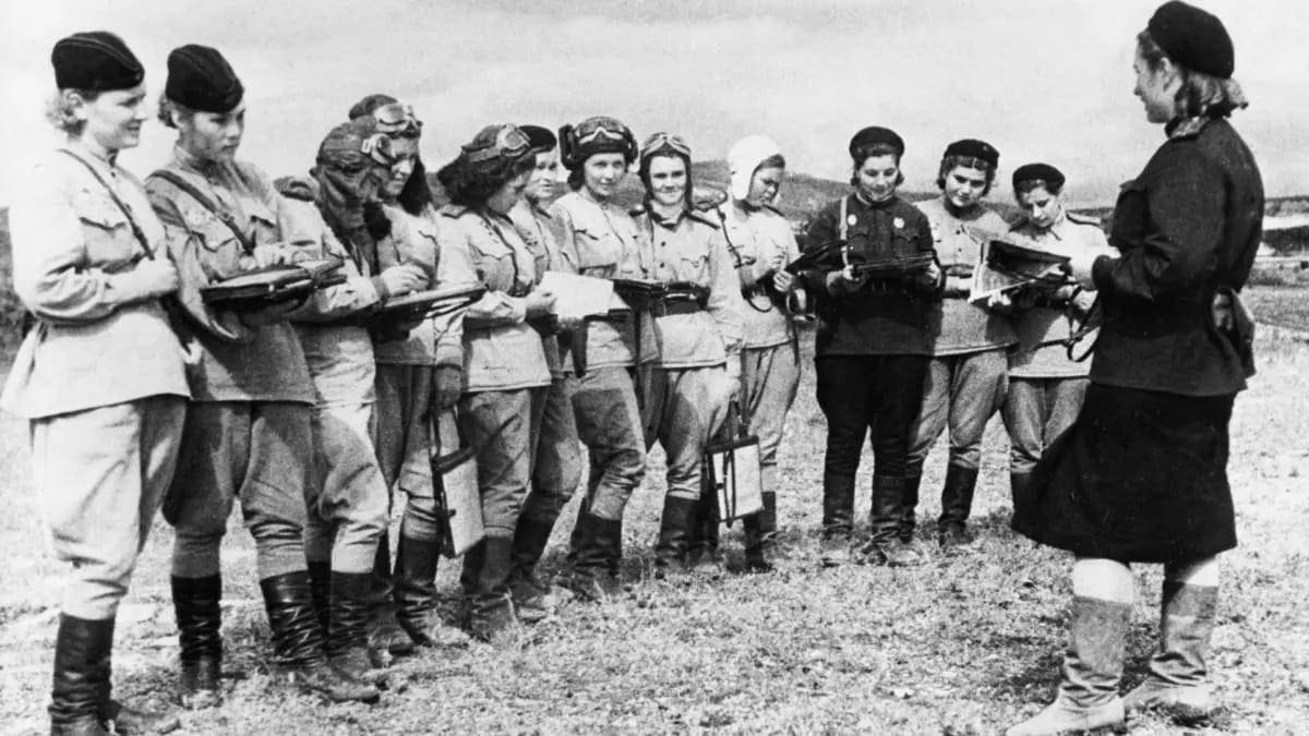 Female fighters of the 588th Night Bomber Regiment, nicknamed the “Night Witches,” lined up and received orders for a bombing mission taking place later that evening. Photo: Getty Images via Wright Museum 