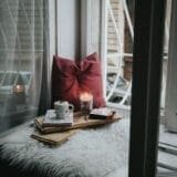 A peaceful wellness journaling setup featuring an open notebook, a candle, and a warm drink—ideal for writing in a mental health blog format.