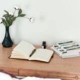 Handwritten letter in a journal on a wooden desk, symbolizing personal reflection, mindset, and personal goals