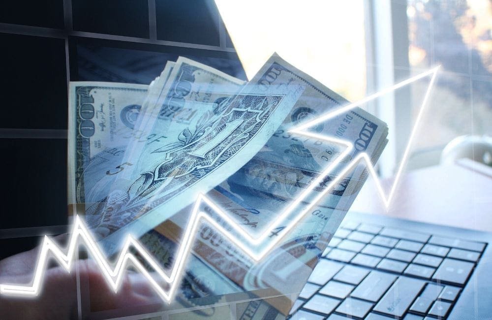 An image of dollar bills on a keyboard.