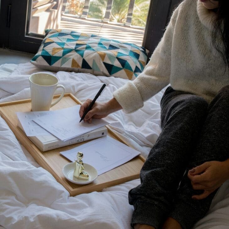 Person practicing self care by journaling reflections on motivation and growth