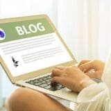 An image of a person writing a blog for an article about blog tools.
