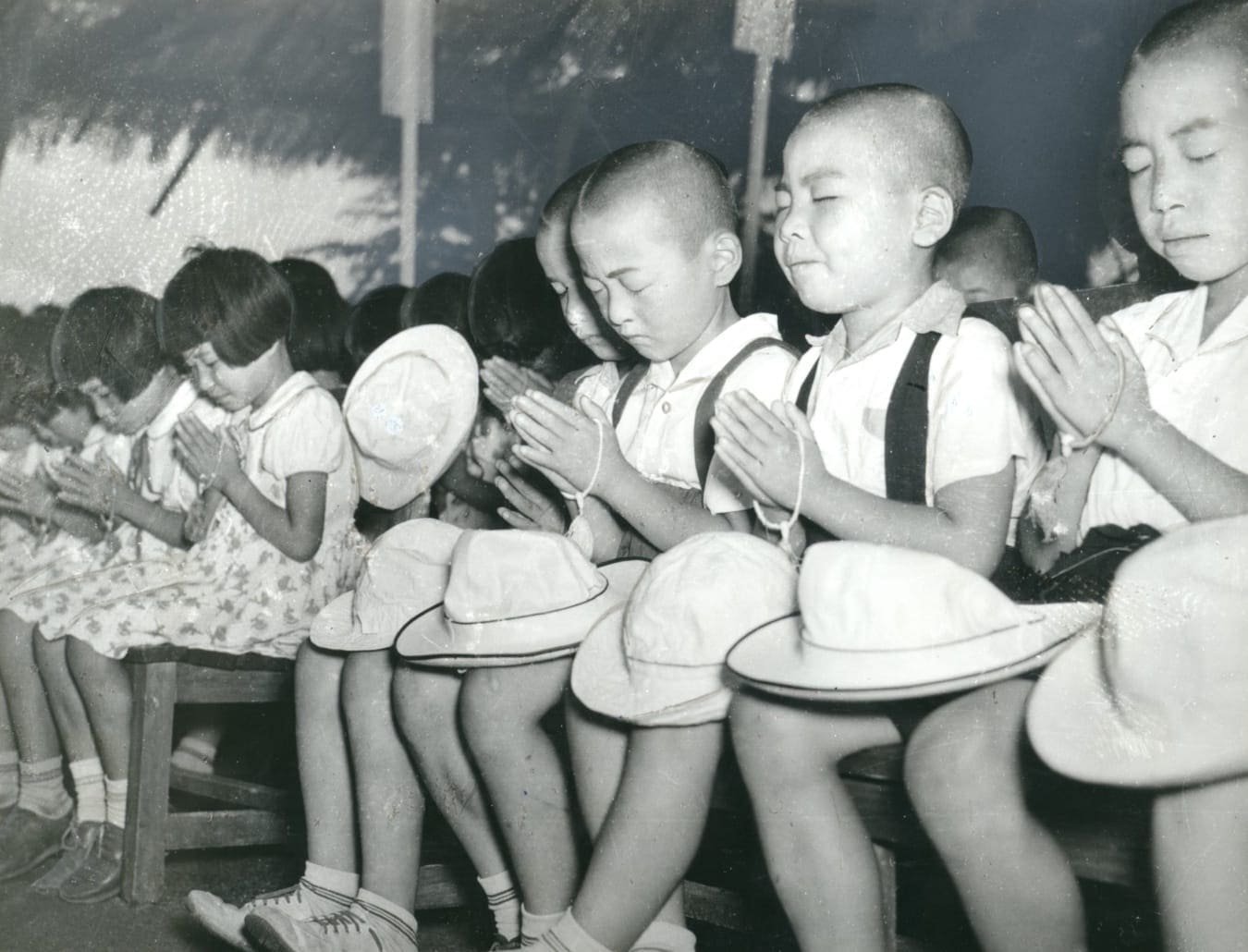 A-bomb orphans pray at a ceremony in Hiroshima on 6 August 1951 marking the sixth anniversary of the nuclear attack. Photo: Chugoku Shimbun, ICAN