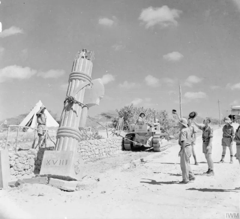 On April 11, 1941, British troops use a bulldozer to topple a fascist stone monument in Kismayu, Italian Somaliland. Photo: Imperial War Museums