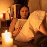 Woman journaling in warm light, practicing manifestation techniques