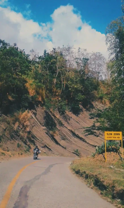 Motorbike on a winding mountain road in Bucari, Leon, symbolizing the joy of investing in experiences through travel and adventure.