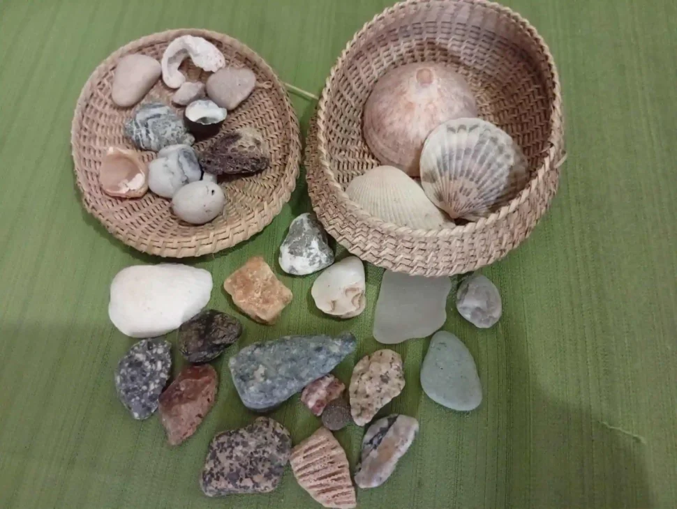 A personal collection of stones and shells gathered from trips, reflecting investing in experiences over material possessions.