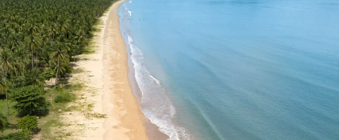 Aerial view of San Vicente’s 14 km Long Beach, stretching endlessly into turquoise seas.