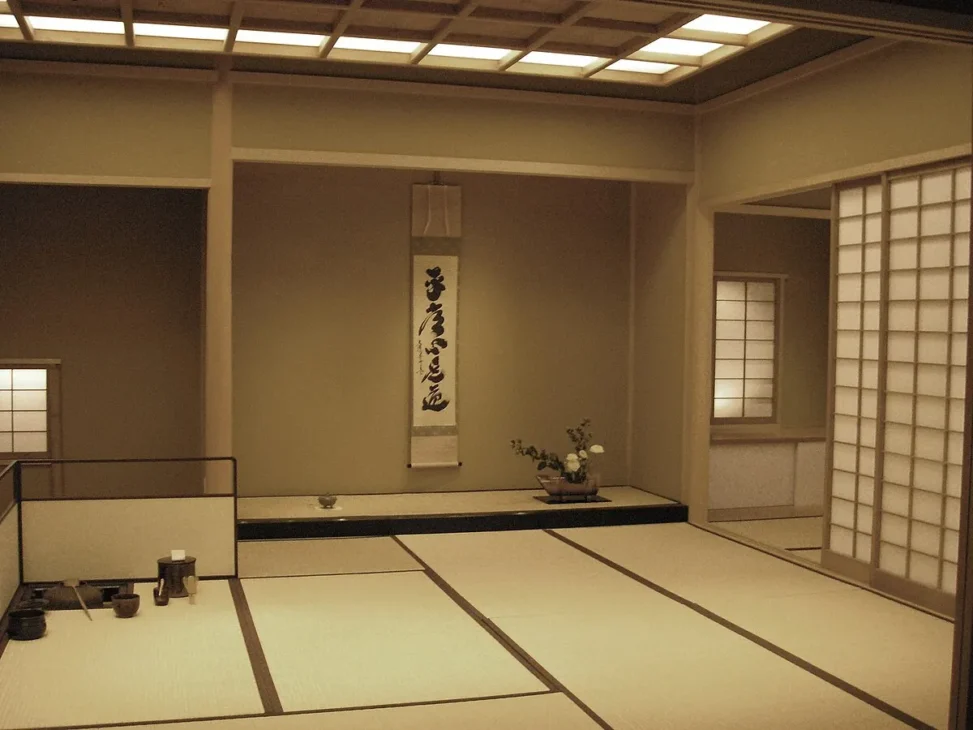 Traditional Japanese tea ceremony room with tatami mats and matcha tea tools.