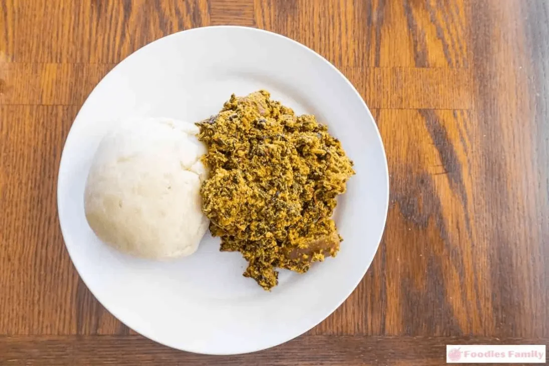 Traditional West African fufu served with soup, made from pounded yams, cassava, or plantains.