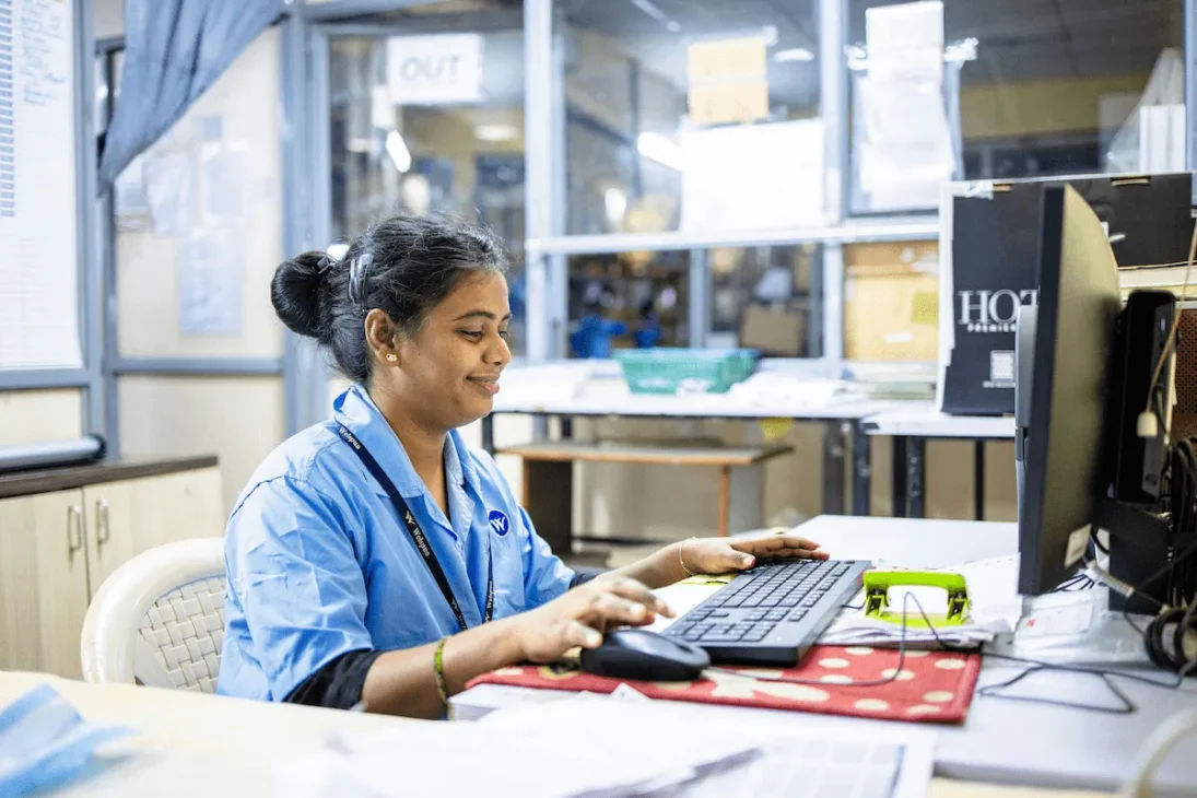 Indian woman working at her office desk with laptop and documents