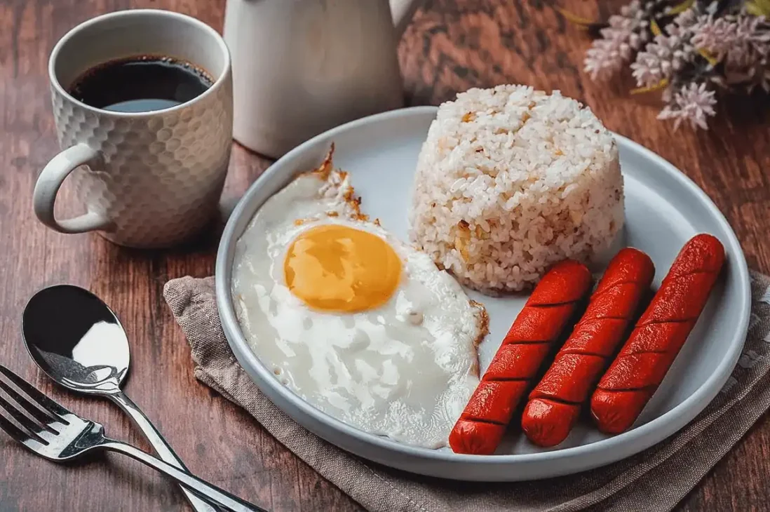 Filipino silog plate with garlic fried rice, fried egg, and tapa meat.