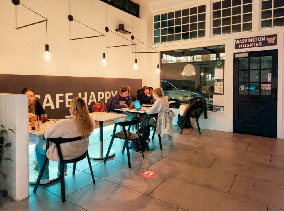 A lively late-night café filled with people chatting and enjoying drinks, representing how cities are redefining nightlife beyond alcohol.