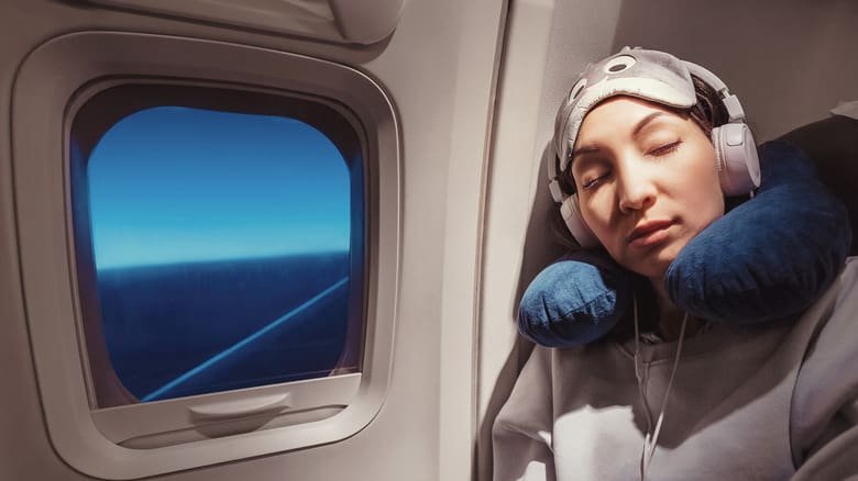 Jet lag tips for traveler making common jet lag mistakes like napping too long, eating off-schedule, and ignoring light exposure.