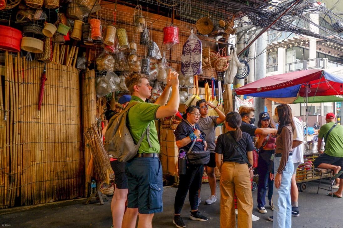 Gen Z ravelers walking through a peaceful local village market with a reusable tote, engaging respectfully with a vendor to represent mindful, ethical slow travel.