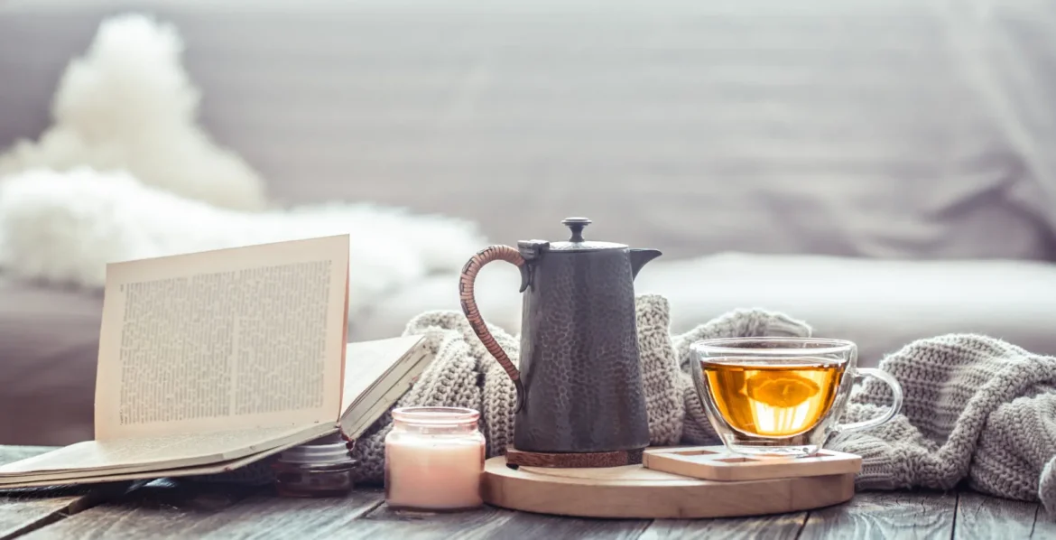 Traveler’s desk with water, antioxidant snacks, facial mist, and morning sunlight, illustrating lifestyle habits that enhance skincare results.