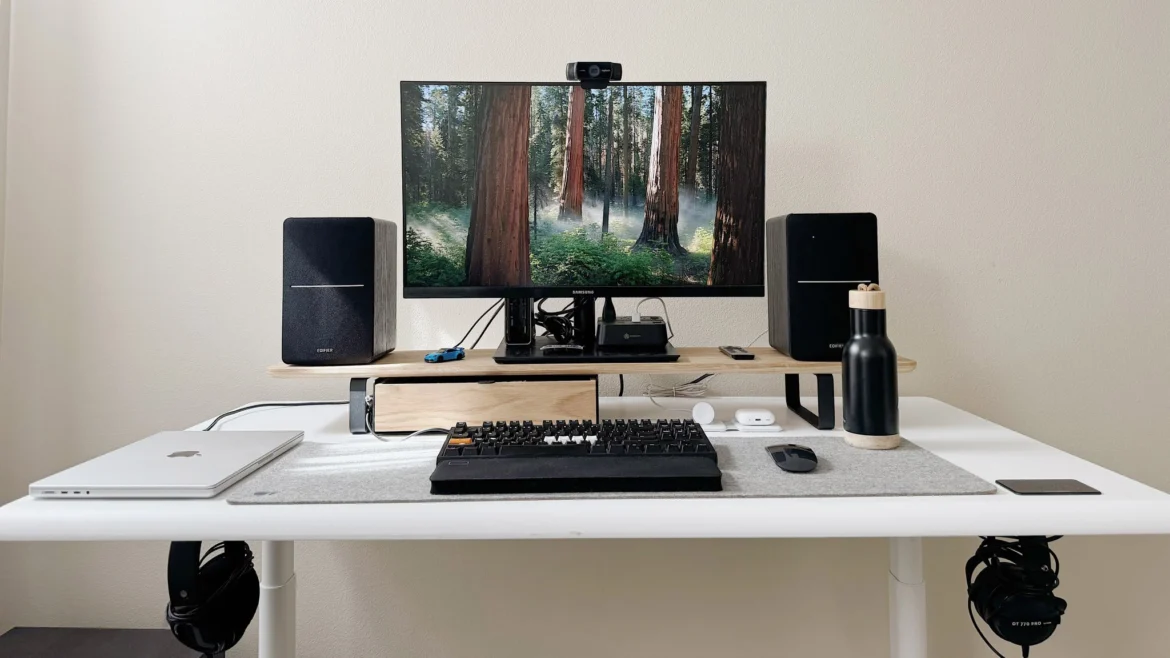 A home office setup with a standing desk, water bottle, and reminder notes, showing small lifestyle adjustments that encourage movement throughout the day.