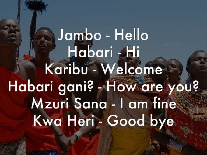 A guide titled with Swahili greetings and their English translations overlaid on an image of a group of people in traditional Kenyan attire. The text lists "Jambo - Hello," "Habari - Hi," "Karibu - Welcome," "Habari gani? - How are you?," "Mzuri Sana - I am fine," and "Kwa Heri - Good bye".