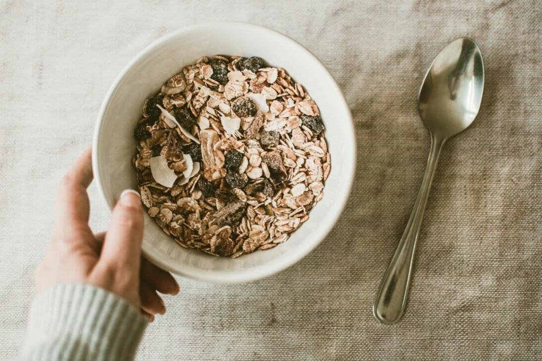 A bowl of oats showing a fiber-rich carbohydrate source that provides steady energy.