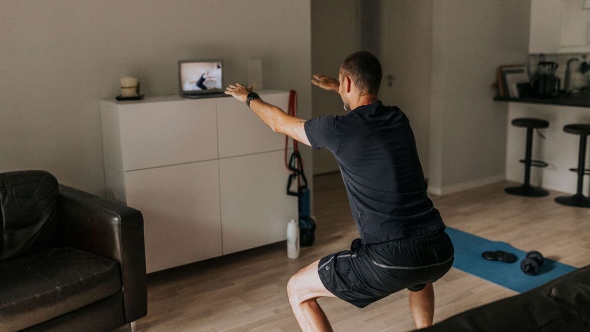 Person doing bodyweight squats and desk push-ups in a home office, with a timer showing a short 5-minute break.