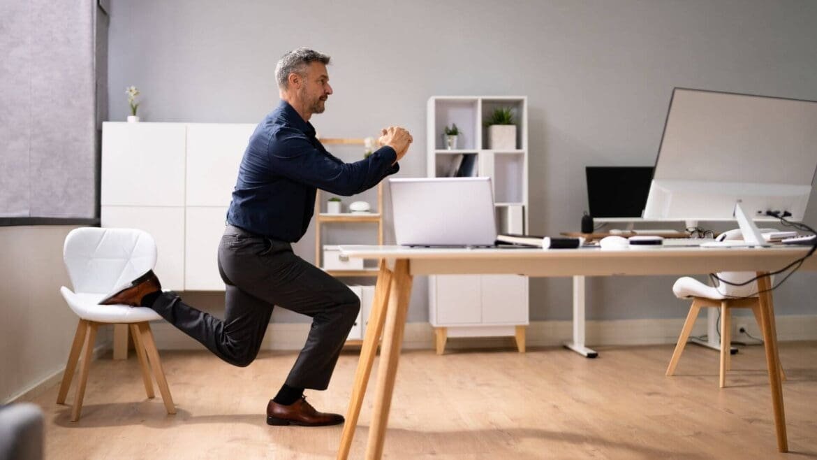 Home office setup with a person performing squats, lunges, and desk push-ups, showing a quick no-equipment workout in progress.