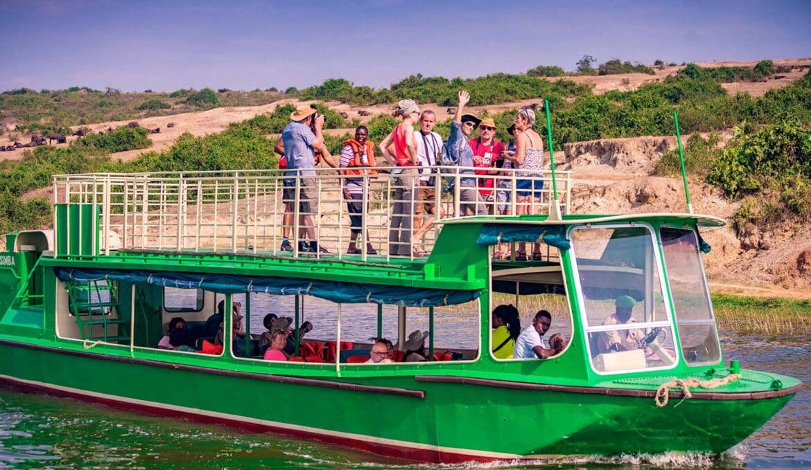 Low-impact ecotourism experience in Uganda, with travelers moving quietly through forest or waterways surrounded by rich biodiversity.