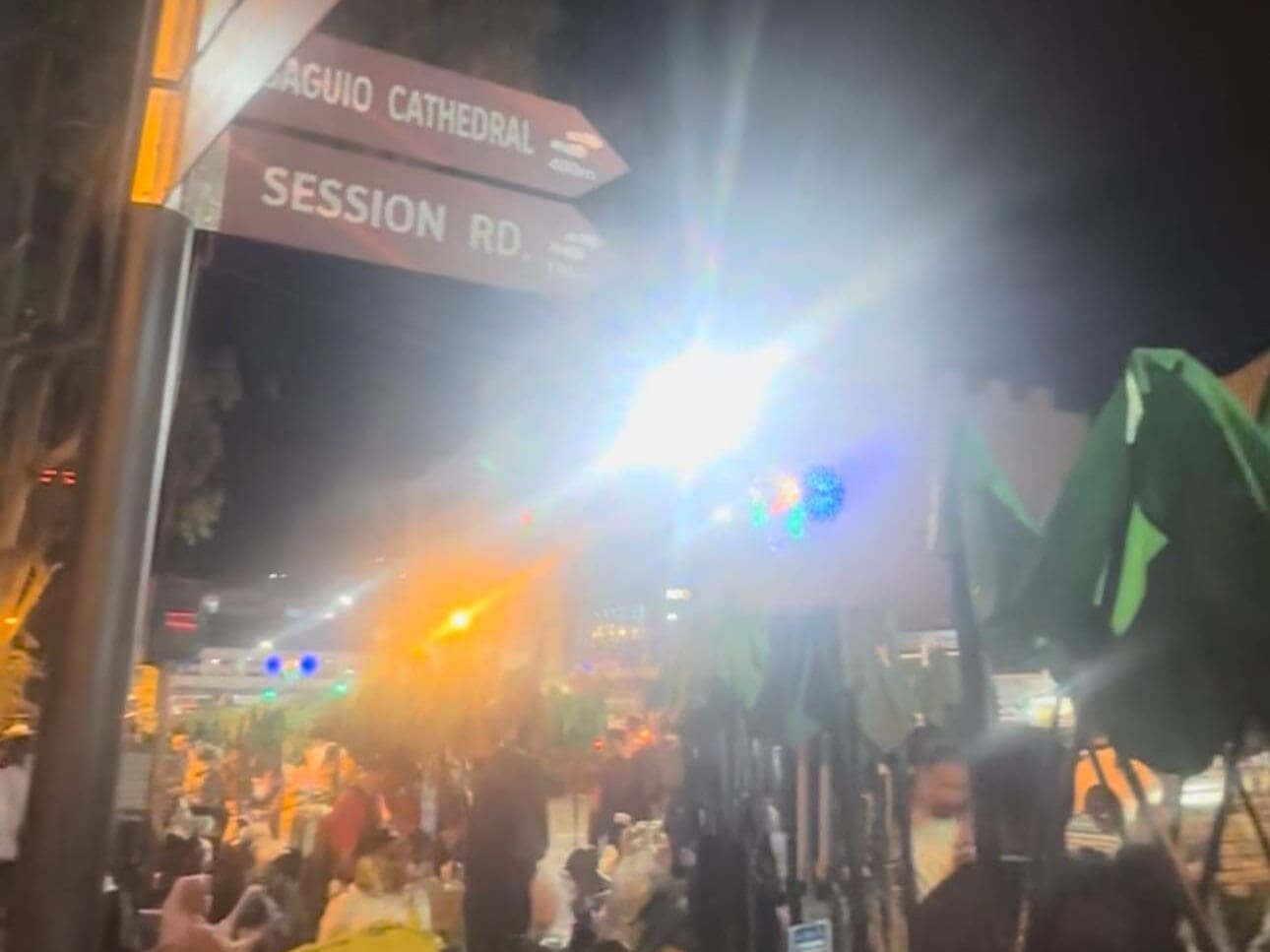 Busy Session Road at night filled with vendors, pedestrians, and bright city lights in Baguio City
