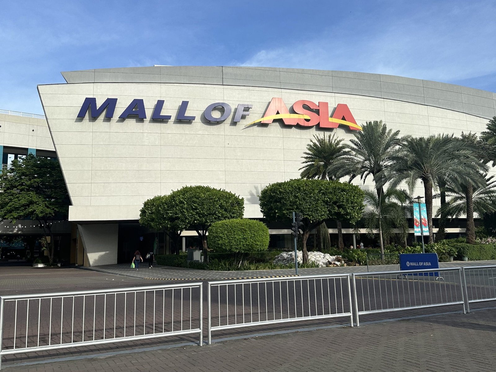 Exterior view of SM Mall of Asia (MOA) in Pasay, Metro Manila, Philippines, showing its sprawling structure and bustling surroundings.
