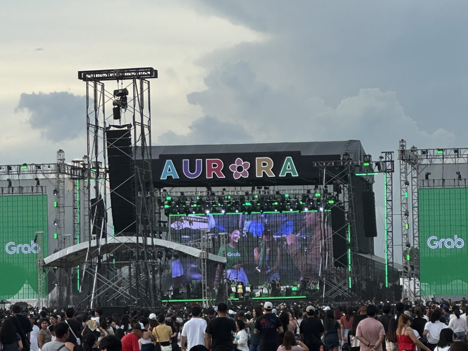 Crowds gathered at the Aurora Festival grounds in Clark, Pampanga, with the large Aurora sign in the background.