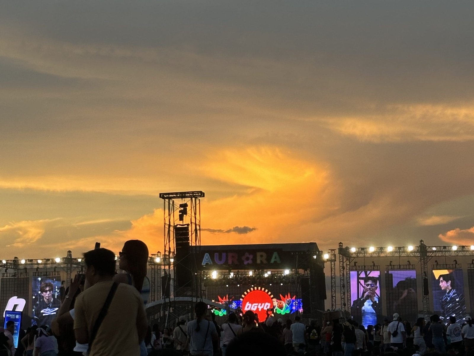 Aurora Festival stage at sunset in Clark, Pampanga, showing the crowd and festival setup during the golden hour.