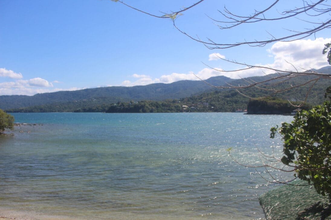 Early morning at White Beach in Puerto Galera with calm waters, soft sunlight.