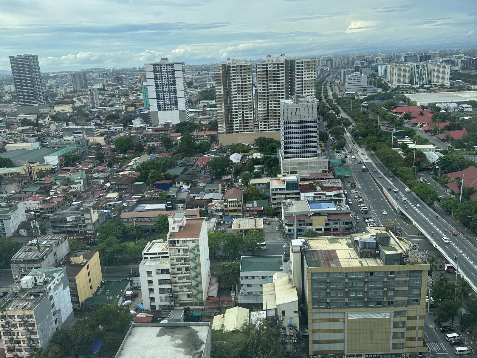 Metro Manila skyline view from hotel balcony featuring modern skyscrapers