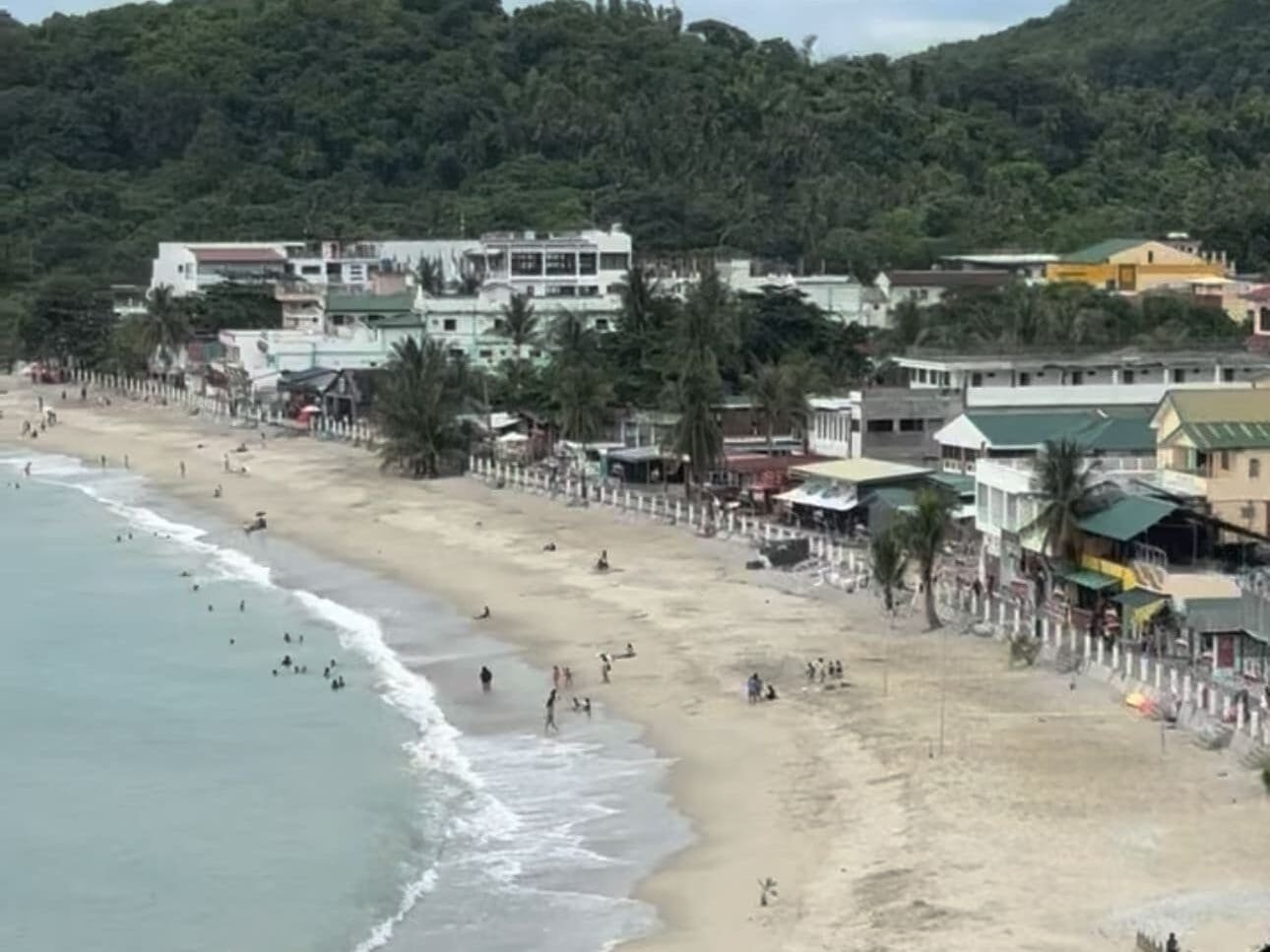 Aerial view of White Beach in Puerto Galera, Oriental Mindoro, Philippines, showing the long stretch of white sand, turquoise waters, and beachfront resorts.