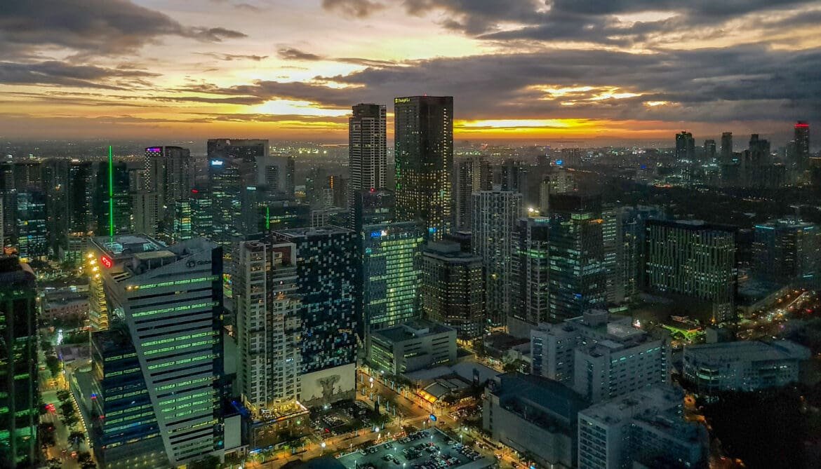 Aerial view of Manila skyline at sunset, highlighting the city’s vibrant energy, urban beauty, and appeal that draws visitors back repeatedly.